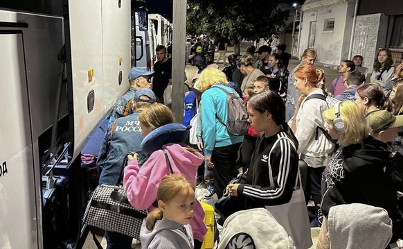epa11550398 A handout picture made available by Russian Emergency ministry press service shows evacuated people from Belgorod and Kursk regions arriving to temporary accommodation points in Nevinnomys ...