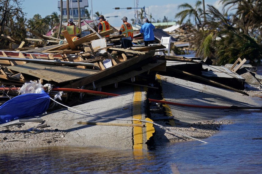CORRECTS THE DATELINE TO SPRING HILL, FLA., AND NOT PINE ISLAND AS ORIGINALLY SENT - Responders from the de Moya Group survey damage to the bridge leading to Pine Island, to start building temporary a ...