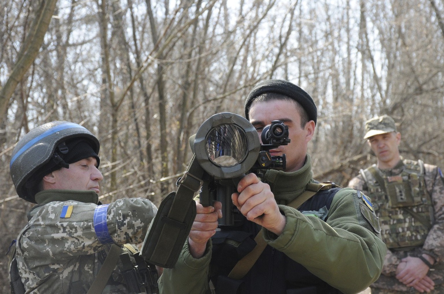 FILE - Ukrainian servicemen study a Sweden shoulder-launched weapon system Carl Gustaf M4 during a training session on the near Kharkiv, Ukraine, April 7, 2022. An interminable and unwinnable war in E ...