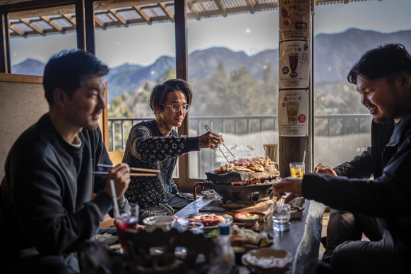 Chef Kiyoshi Fujimoto holding trays of bear meat as he prepares to cook it in his restaurant in Sapporo, in Hokkaido Prefecture, northern Japan.