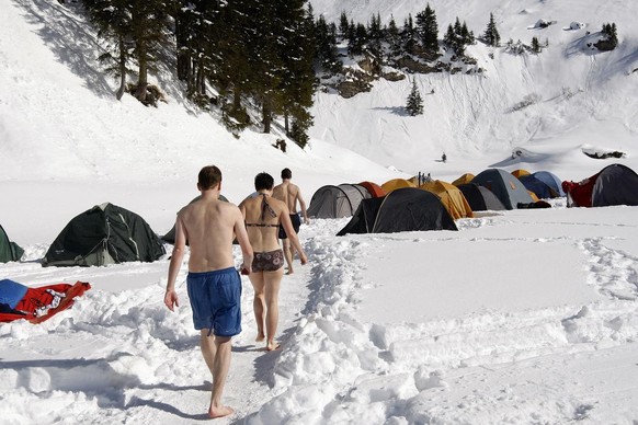 A group of friends organized an outdoor jacuzzi on the frozen Lake Lioson, 1850 meters above sea level, and are having a good time, at the Col des Mosses, Swiss Alpes, Switzerland, Saturday 21 Februar ...