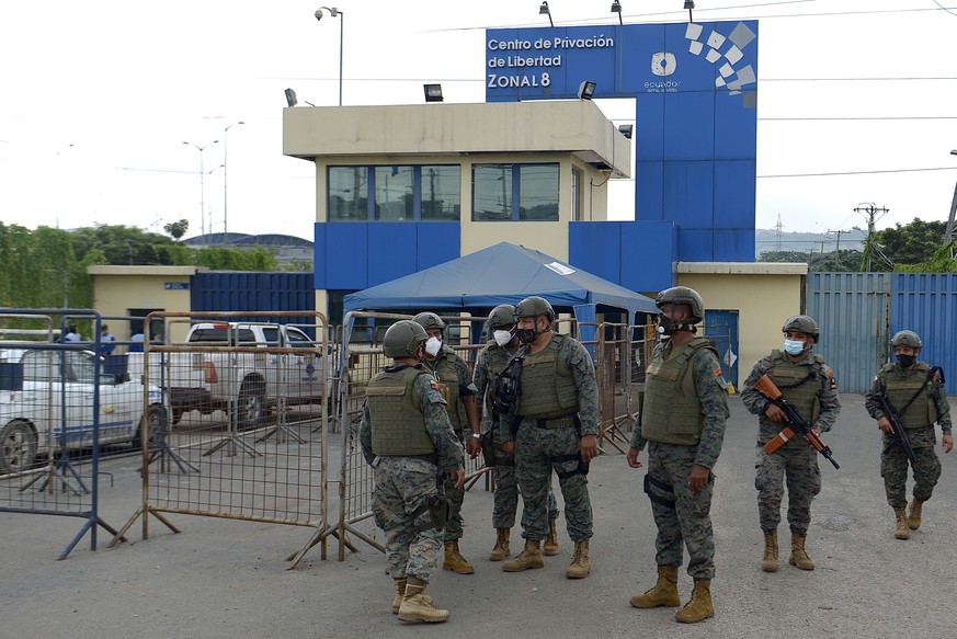 epa09032938 Military guard the exterior of the Guayaquil prison after the acts of violence experienced inside, in Guayaquil, Ecuador, 23 February 2021. More than 60 inmates died this Tuesday in Ecuado ...