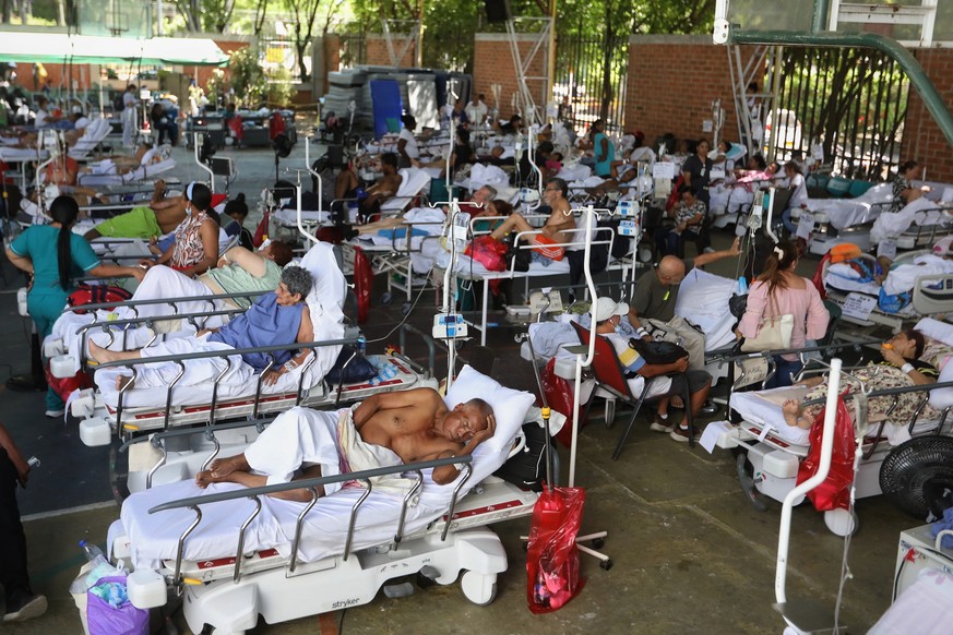 KEYPIX - Patients from a clinic evacuated due to earthquake damage lie in beds at a temporary facility set up in a gymnasium at a nearby school in Cali, Colombia, Tuesday, Aug. 11, 2026. (AP Photo/San ...