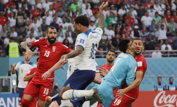 epa10317924 Goalkeeper Ali Beiranvand of Iran collides with teammate Majid Hosseini (R) during the FIFA World Cup 2022 group B soccer match between England and Iran at Khalifa International Stadium in ...