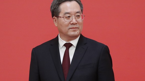 epa10260289 New member of the Standing Committee of the Political Bureau of the 20th Chinese Communist Party (CPC) Central Committee Ding Xuexiang looks on during a press conference at the Great Hall  ...