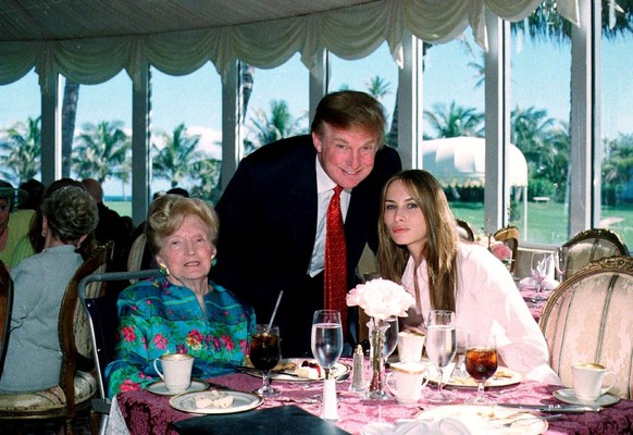 Portrait of, from left, American socialite Mary Trump, her son, real estate developer Donald Trump, and his girlfriend (and future wife), former model Melania Knauss, as they pose together in the tea  ...