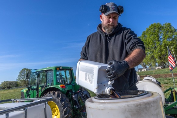 Co-Owner of Soil Regen and first generation farmer, Russell Hedrick, prepares a blend of minerals, biologicals, and fertilizers to be sprayed onto his fields while they are being seeded in Hickory, No ...