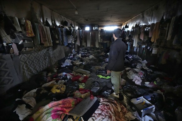 A man looks at a room of the infamous Saydnaya military prison, just north of Damascus, Syria, Monday, Dec. 9, 2024. .(AP Photo/Hussein Malla)