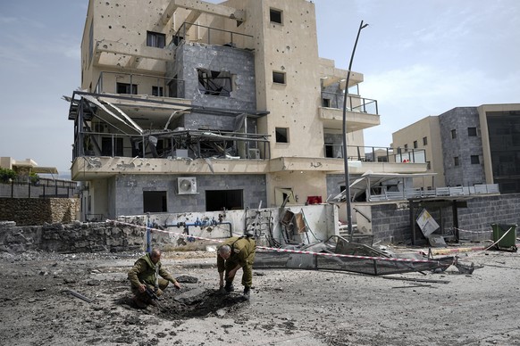 FILE - Israeli security forces examine the site hit by a rocket fired from Lebanon, in Kiryat Shmona, northern Israel, Wednesday, March 27, 2024. Lebanon&#039;s militant Hezbollah group is introducing ...