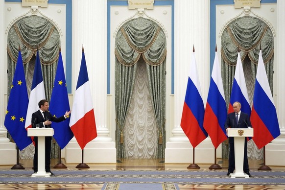 epa09736603 Russian President Vladimir Putin (R) listens during a joint press conference with French President Emmanuel Macron after their talks in the Kremlin in Moscow, Russia, 07 February2022. Inte ...