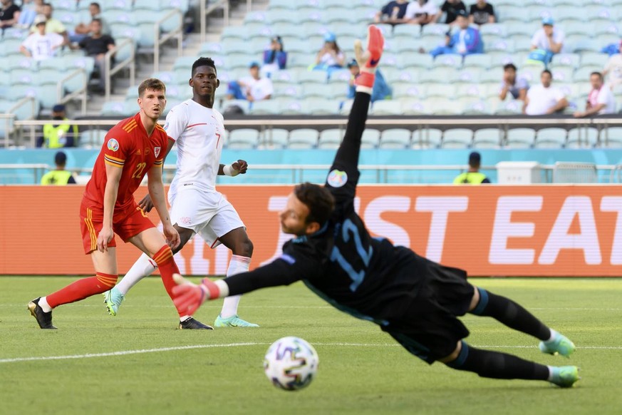 Wales&#039;s defender Chris Mepham, Switzerland&#039;s forward Breel Embolo, and Switzerland&#039;s goalkeeper Yvon Mvogo, from left, in action during the Euro 2020 soccer tournament group A match bet ...