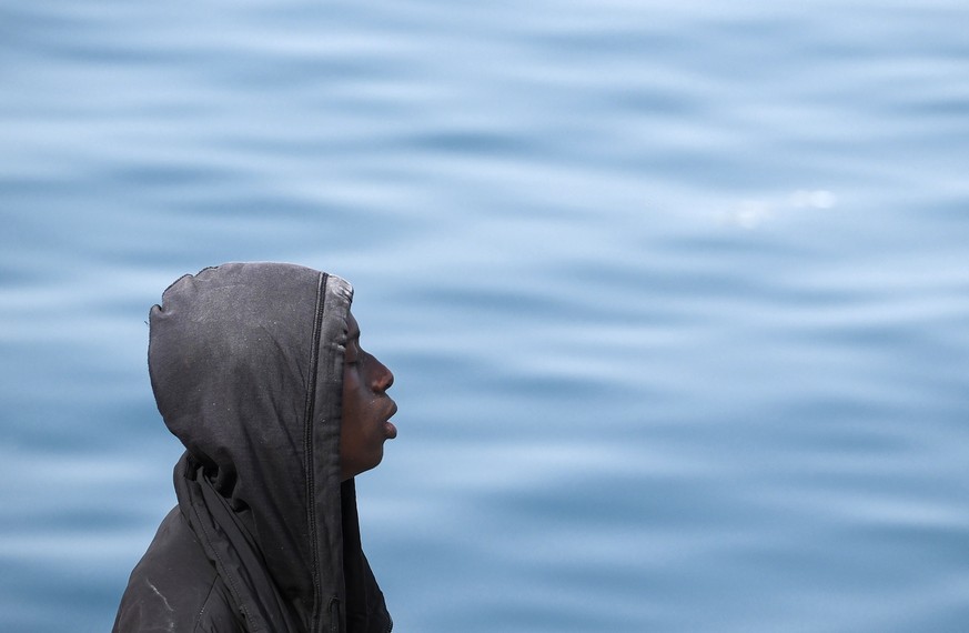 epaselect epa11486082 A migrant reacts upon arrival to Arguineguin port, Gran Canaria, Canary islands, Spain, 18 July 2024. Spanish Salvamento Maritimo Safe and Rescue brigade helped 158 migrants as t ...