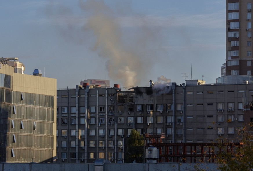 epa10248561 Smoke billows from a damaged building after shelling in downtown Kyiv (Kiev), Ukraine, 17 October 2022, amid the Russian invasion. Several residential buildings were damaged as a result of ...