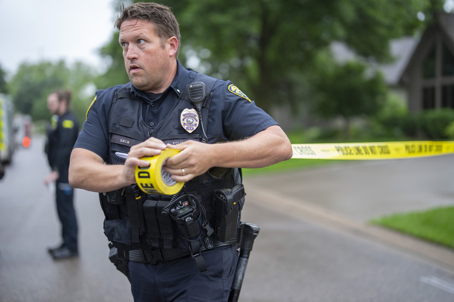 Brooklyn Park Police Lieutenant Hjelm sets up a perimeter with police tape near the scene of a shooting in Brooklyn Park, Minn. on Saturday, June 14, 2025. (Alex Kormann/Star Tribune via AP)
Minnesota ...