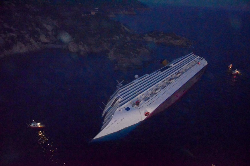 epa03059655 An aerial view of the 'Costa Concordia' cruise ship just off the island of Giglio, northern Italy, 14 January 2012, after it ran aground here late 13 January evening. At least 50 ...