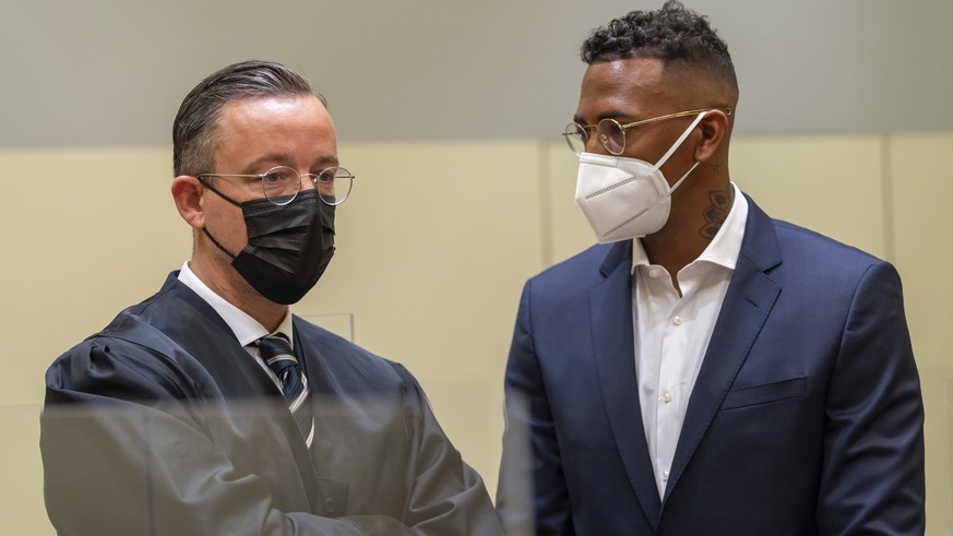 Professional footballer and former national player Jerome Boateng, right, stands with his lawyer Kai Walden, left, at the beginning of the trial against him at the District Court in Munich, Germany, T ...