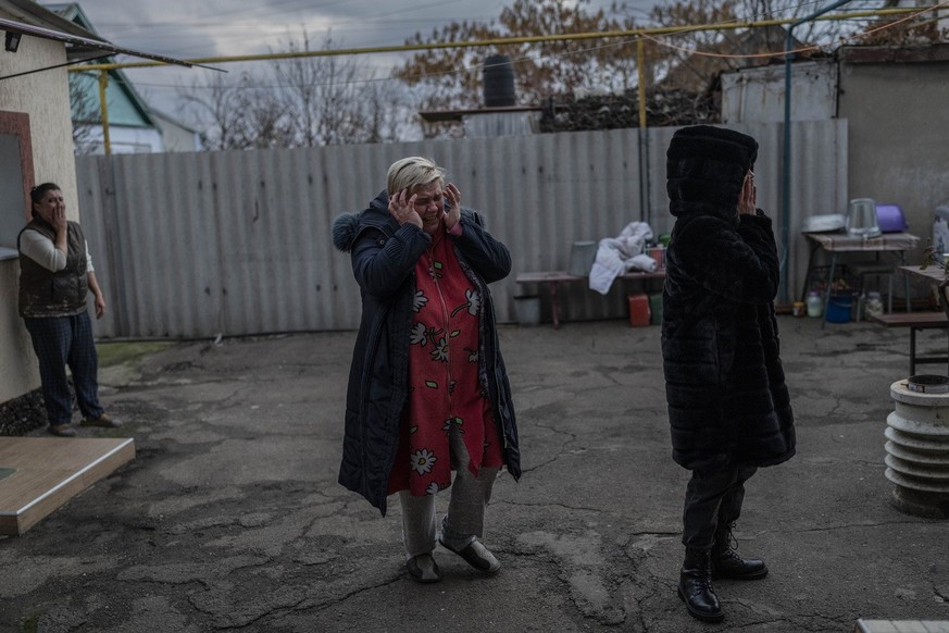 Natalia Voblikova, center, reacts after knowing that her son Artur was seriously injured after a Russian strike in Kherson, southern Ukraine, Tuesday, Nov. 22, 2022. Artur Voblikov, 13, was injured af ...