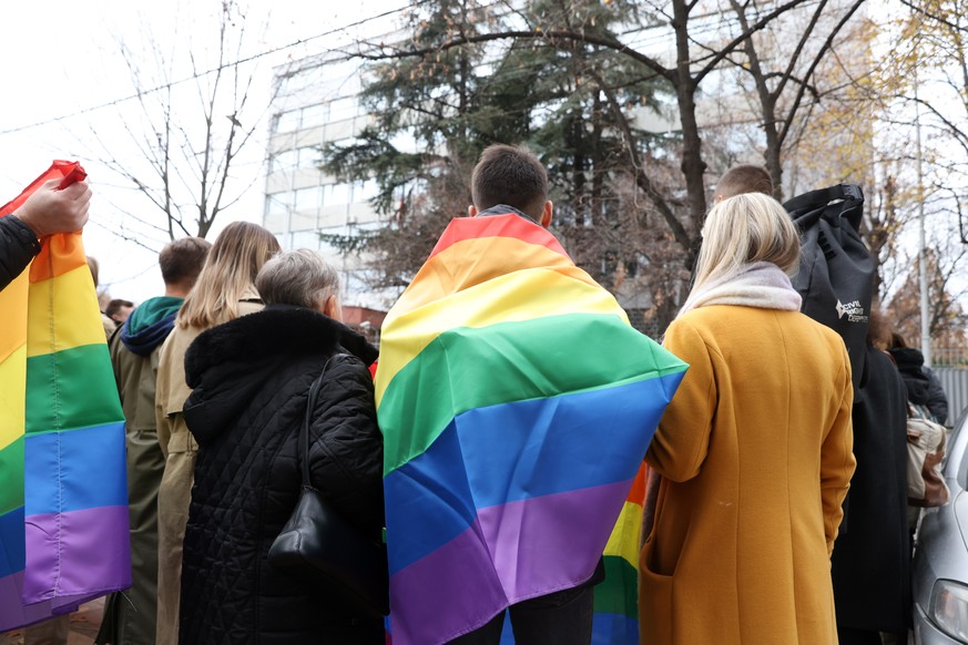 epa11026426 An activist draped in a rainbow colored flag takes part in a protest against Russia&#039;s banning of the LGBT movement, in front of the embassy of Russia in Belgrade, Serbia, 13 December  ...