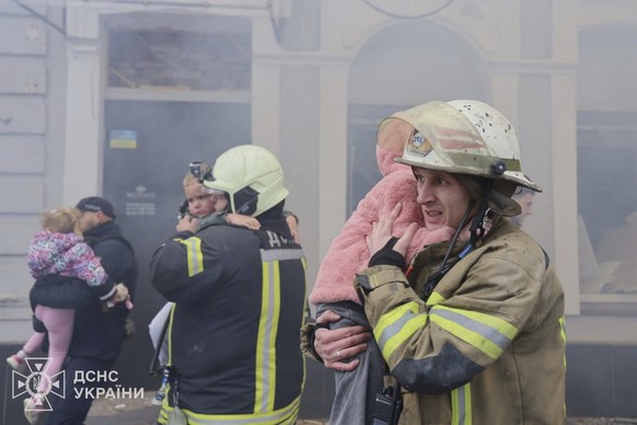 In this photo provided by the Ukrainian Emergency Service, rescuers evacuate children after Russian drones hit a city kindergarten during an attack in Kharkiv, Ukraine, Wednesday, Oct. 22, 2025. (Ukra ...