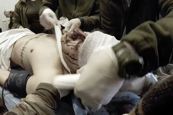 Yuliia Paievska, known as Taira, and other medical personnel bandage the head of an injured serviceman Mariupol, Ukraine, Feb. 24, 2022. Using a body camera, she recorded her team&#039;s frantic effor ...