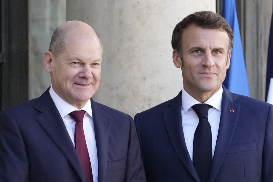 French President Emmanuel Macron, right, welcomes German Chancellor Olaf Scholz at the Elysee Palace in Paris, Wednesday, Oct. 26, 2022. French President Emmanuel Macron is scheduled to meet in Paris  ...