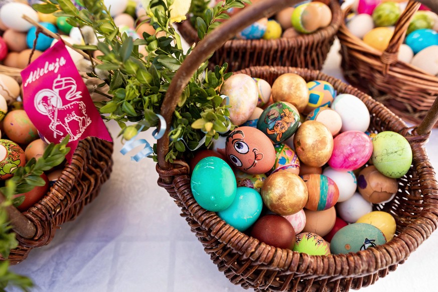 epa09894828 Painted eggs sit in a basket during the Easter breakfast ���Without Borders��� for people in need, organized by the Foundation for Mutual Help Barka, in Poznan, Poland, 17 April 2022. The  ...
