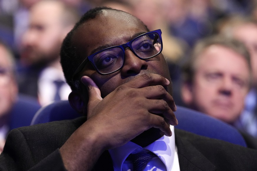 Britain&#039;s Chancellor of the Exchequer Kwasi Kwarteng listens to Britain&#039;s Prime Minister Liz Truss making a speech at the Conservative Party conference at the ICC in Birmingham, England, Wed ...