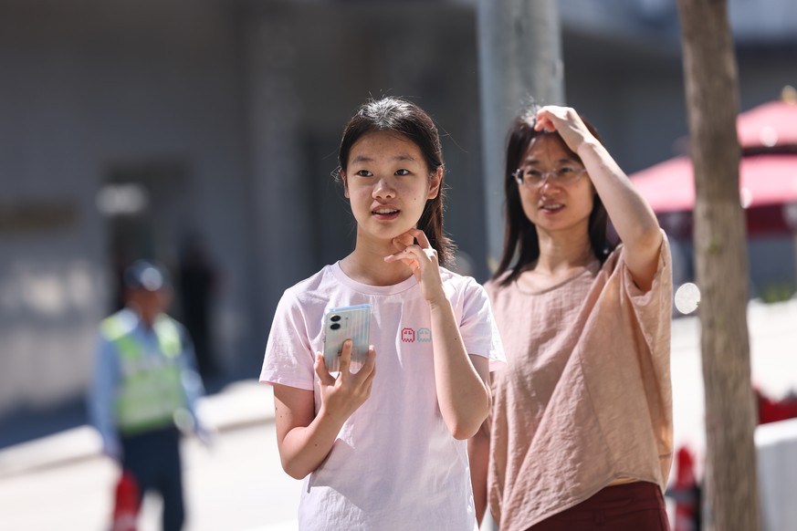 epa13021397 A student prepares to enter a school for China's annual National College Entrance Examination in Beijing, China, 07 June 2026. The examination, commonly known as Gaokao, runs from 07  ...