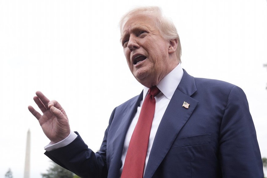 KEYPIX - President Donald Trump talks to reporters on the South Lawn of the White House before he boards Marine One en route to Joint Base Andrews, Md., Friday, Aug. 1, 2025, in Washington. (AP Photo/ ...