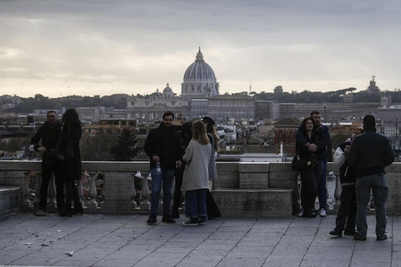 epa09736215 People gather at the Pincian Hill (or Pincio), overlooking Saint Peter&#039;s dome, in Rome, Italy, 07 February 2022. Italy is taking a step towards normality on 07 February with the easin ...