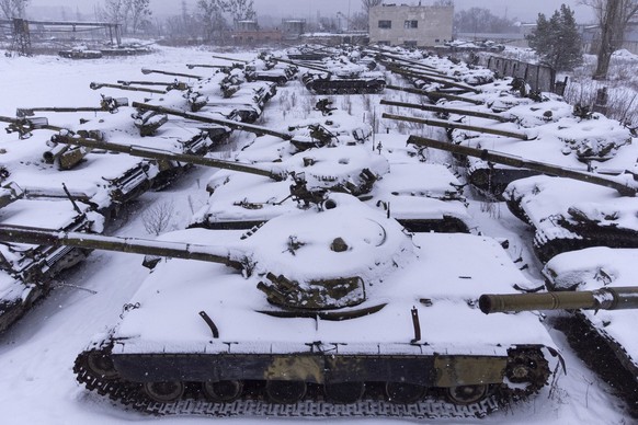 Old T-64 tanks covered by snow stands at the depot site at the Tank Repair Plant in Kharkiv, Ukraine, Monday, Jan. 31, 2022. Kharkiv is just 40 kilometers (25 miles) from some of the tens of thousands ...