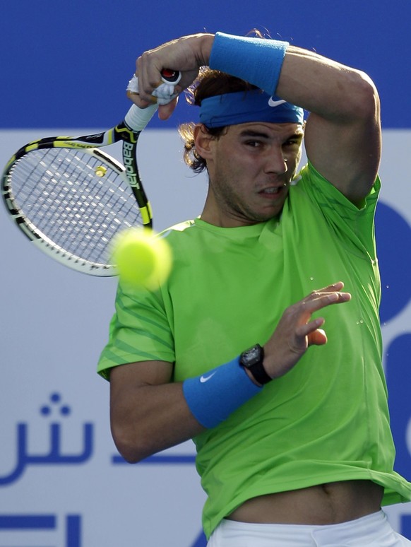 Spain's Rafael Nadal returns the ball to Roger Federer from Switzerland during the final day of the Abu Dhabi Mubadala Tennis Championship, Saturday, Dec. 31, 2011 in Abu Dhabi, United Arab Emira ...