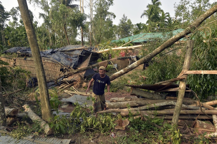 230516 -- COX S BAZAR, May 16, 2023 -- A man tries to retrieve his belongings after his house was damaged by cyclone Mocha in Cox s Bazar, Bangladesh, on May 15, 2023. Cyclone Mocha, packing winds of  ...