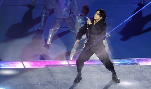epa10316148 South Korean pop singer Jung Kook performs during the Opening Ceremony prior to the FIFA World Cup 2022 group A Opening Match between Qatar and Ecuador at Al Bayt Stadium in Al Khor, Qatar ...