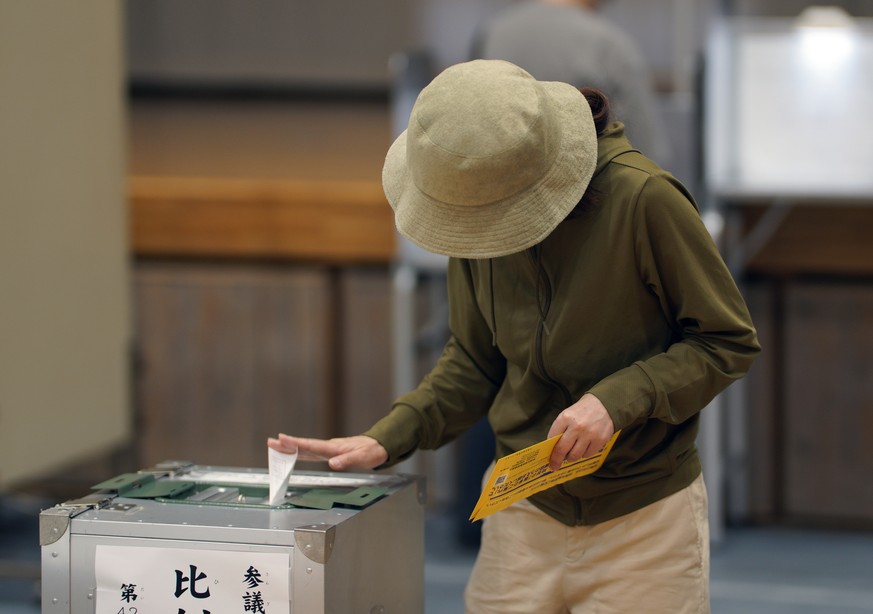 epa12248700 A voter casts her ballot for the elections for the Upper House of the Parliament, at a school gymnasium in Tokyo, Japan, 20 July 2025. Half of the seats of the Upper House are up for re-el ...