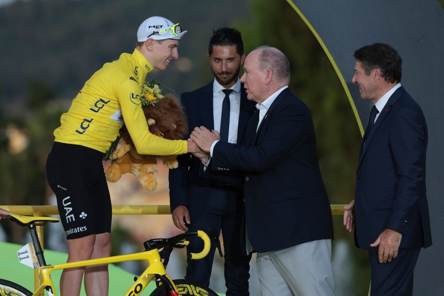 NICE, FRANCE - JULY 21: Race leader and yellow jersey Tadej Pogacar of Slovenia and UAE Team Emirates celebrates with Prince Albert II of Monaco and Mayor of Nice Christian Estrosi during the podium c ...