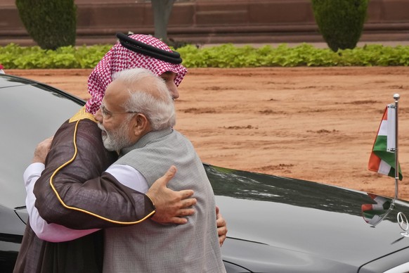Indian Prime Minister Narendra Modi hugs Crown Prince Mohammed bin Salman of Saudi Arabia upon his arrival for a ceremonial reception at the Indian presidential palace, in New Delhi, India, Monday, Se ...