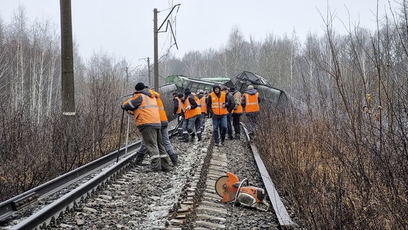 In this photo released by Official telegram channel of the Moscow Railway - a branch of the Russian Railways Company on Saturday, Nov. 11, 2023, Russian Railways Company employees works at the side of ...