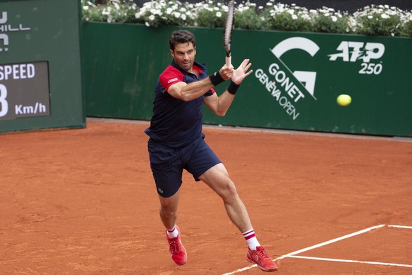 Pablo Andujar, of Spain, returns a ball to Roger Federer, of Switzerland, during their second round match, at the ATP 250 Geneva Open tournament in Geneva, Switzerland, Monday, May 17, 2021. The match ...