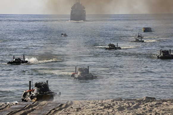 epa09464238 A handout photo made available by the Russian Defence Ministry press service shows marines of the Northern Fleet practice the tasks of amphibious assault landing on an unequipped coast dur ...
