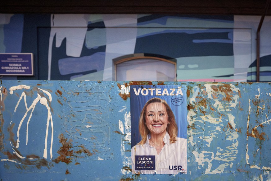 A poster of Elena Lasconi, presidential candidate who entered the presidential runoff in second position, is placed outside the closed voting station where Calin Georgescu, an independent candidate fo ...