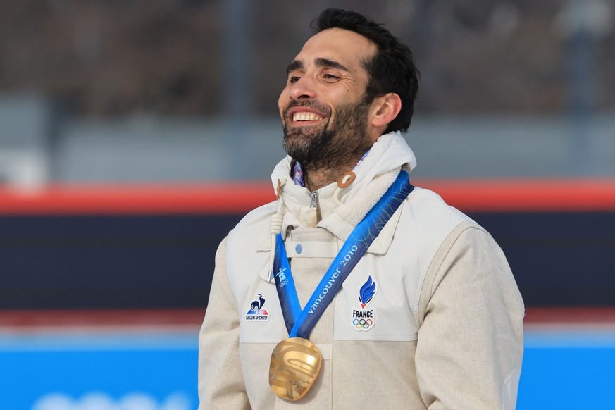 epa12742595 Martin Fourcade of France receives the gold medal for the Men 15km mass start race at the Vancouver 2010 Olympic Winter Games at the Milano Cortina 2026 Winter Olympic Games, in Anterselva ...