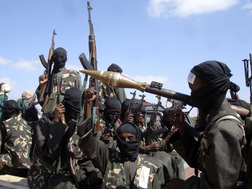 FILE - Armed al-Shabab fighters ride on pickup trucks as they prepare to travel into the city, just outside the capital Mogadishu, in Somalia on Dec. 8, 2008. Somali authorities said Monday, Oct. 3, 2 ...