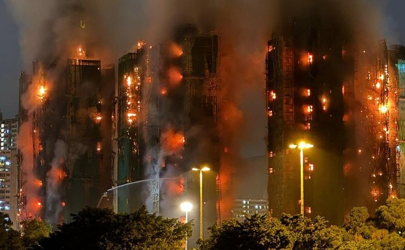 Thick smoke and flames rise as a major fire engulfs several apartment blocks at the Wang Fuk Court residential estate in Hong Kong&#039;s Tai Po district on November 26, 2025. At least four people wer ...
