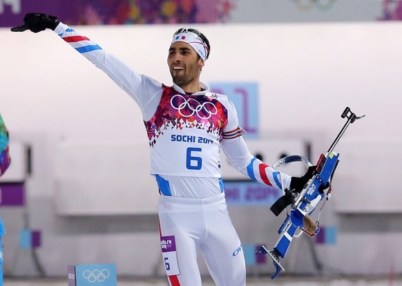 epa04067303 Martin Fourcade of France celebrates after the Men&#039;s 12.5 km Pursuit in Laura Cross-country Ski &amp; Biathlon Center at the Sochi 2014 Olympic Games, Krasnaya Polyana, Russia, 10 Feb ...