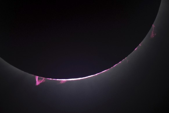 Solar flares and a solar prominence are seen as the moon covers the sun during a total solar eclipse seen from Progressive Field in Cleveland on Monday, April 8, 2024, before the Cleveland Guardians h ...