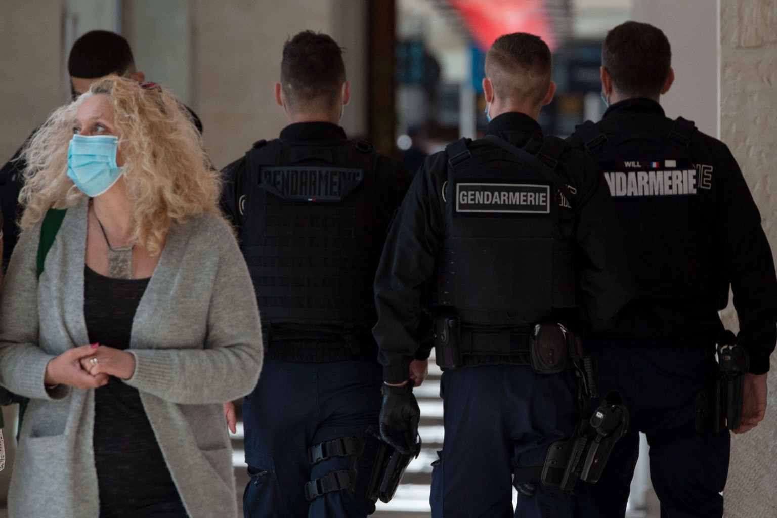 epa09101051 Traveler wearing a face mask and policemen walk on the platform of Saint-Jean train station in Bordeaux, France, 27 March 2021. French Prime Minister Castex on March 18 announced additiona ...