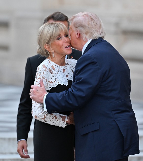 VERSAILLES, FRANCE - JUNE 17: French First Lady Brigitte Macron, French President Emmanuel Macron, and U.S. President Donald Trump attend a dinner at the Palace of Versailles, officially marking the 2 ...