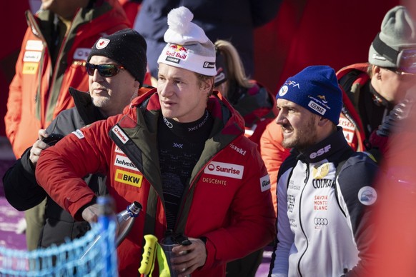 Marco Odermatt of Switzerland, left, and Nils Allegre of France, right, react in the finish area during the men&#039;s Super G race at the Alpine Skiing FIS Ski World Cup, in Wengen, Switzerland, Frid ...