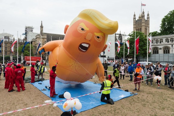 A 20-feet tall &amp;quot;Trump Baby&amp;quot; balloon depicting the President of the United Stetes as an angry orange infant with a smartphone, is being inflated in Parliament Square on the second day ...